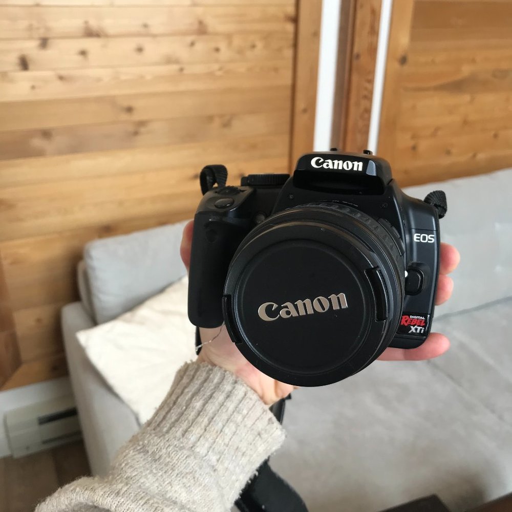 Cannon Rebel XTI DSLR with two lenses, battery, charger, cords, strap and bag